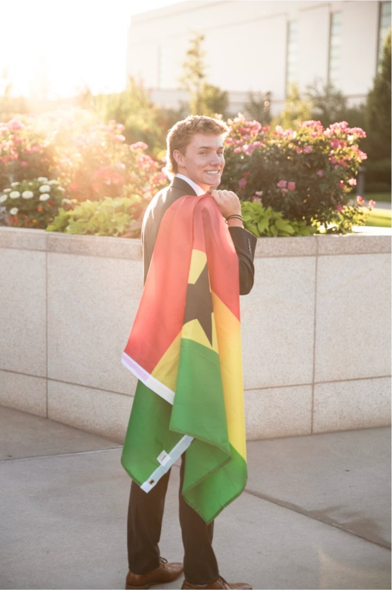 Elder Archibald with the Ghana flag over his shoulders